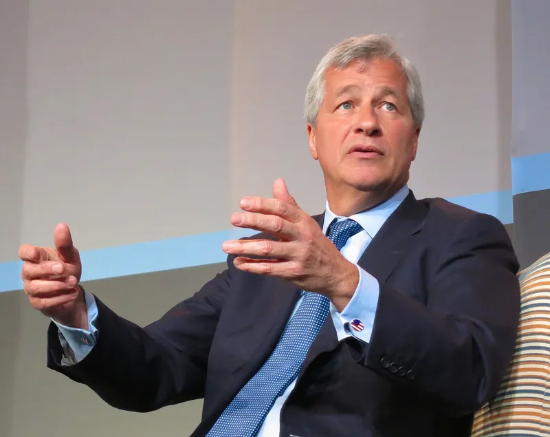 Jamie Dimon, Chairman and CEO of JPMorgan Chase, speaking at a conference podium.